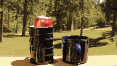 can of coke jumping from one mug to another