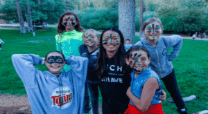 Campers posing with face paint.