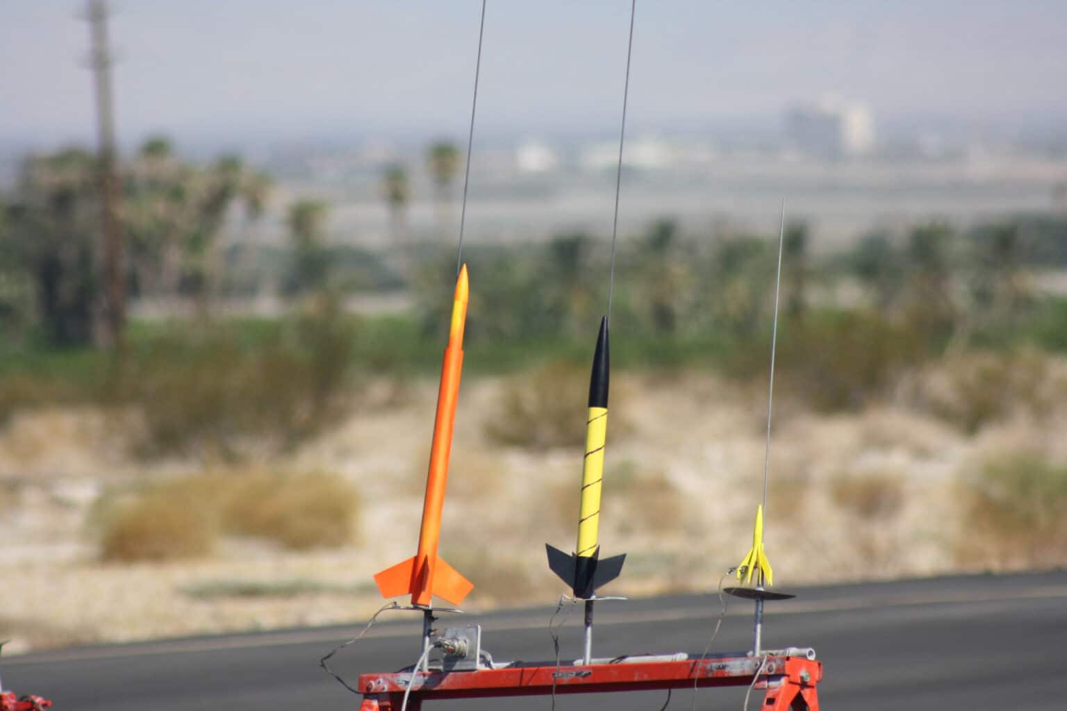 Three rockets on stands.