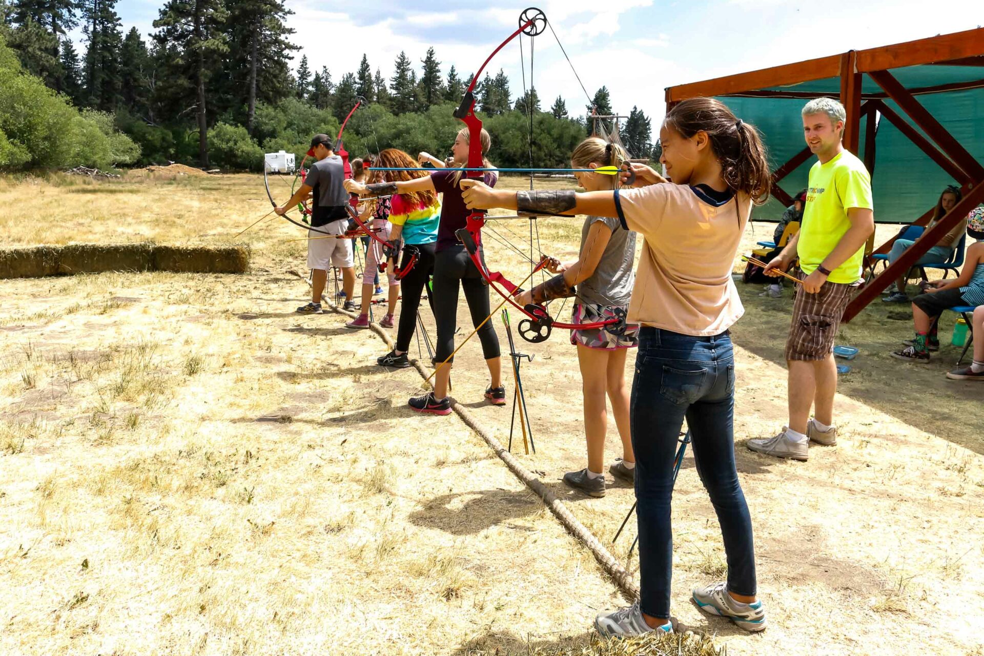 Kids shooting bows and arrows.