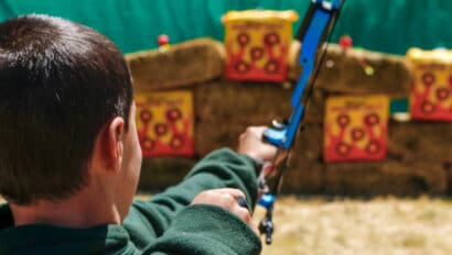 Boy shooting arrow.