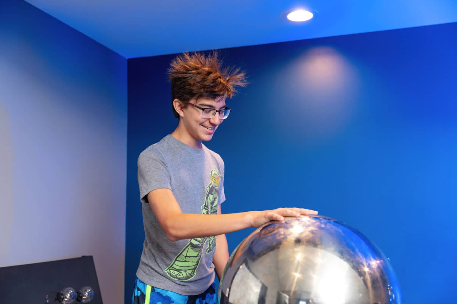 Boy smiling while touching static.