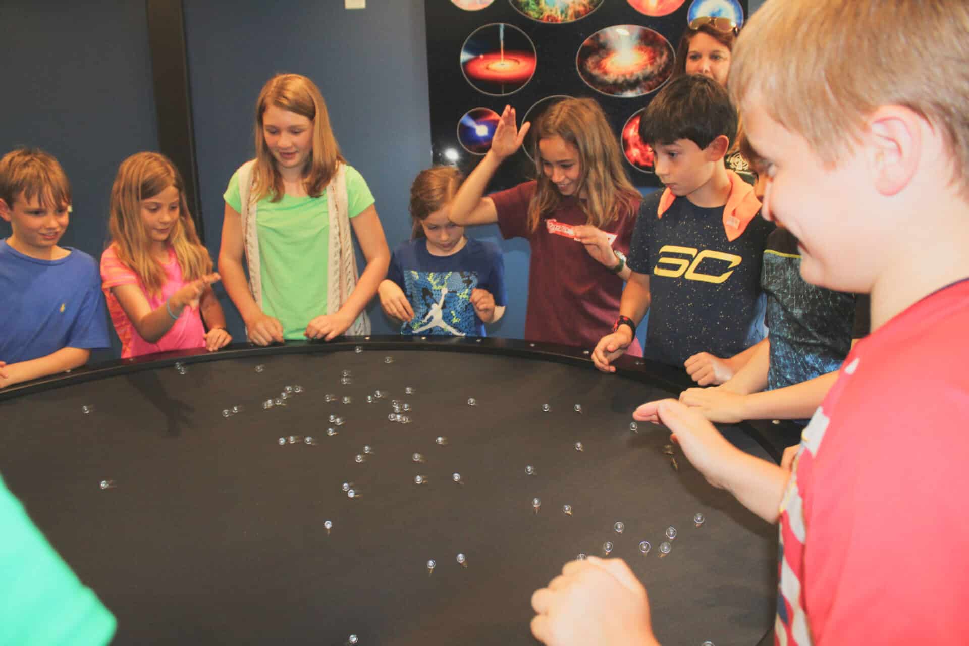 Kids playing with marbles.