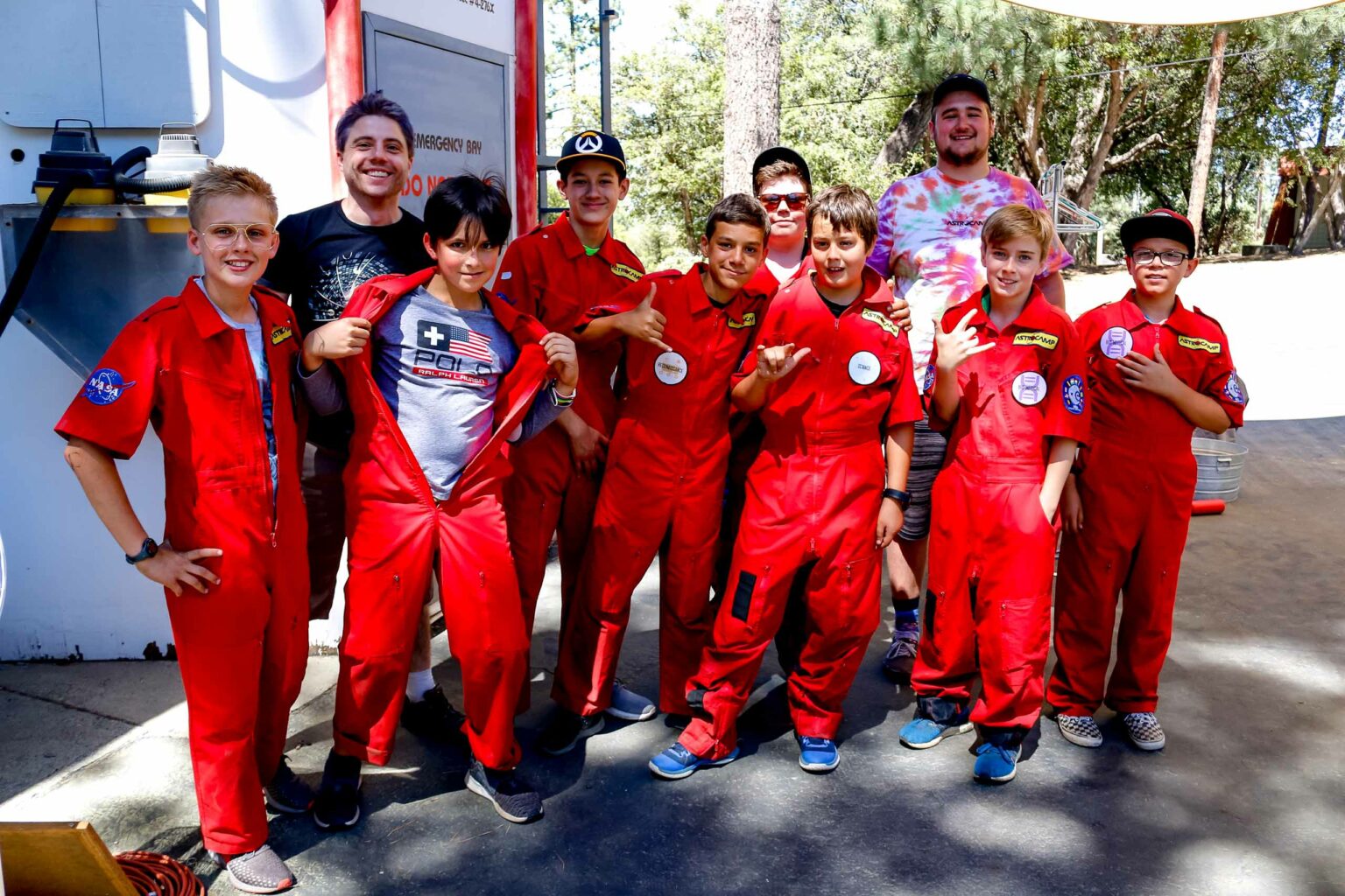 Boys posing in red jumpsuits.