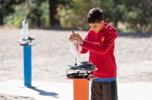 Boy building bottle rocket.