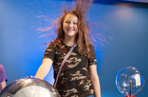 Girl smiling with static hair.