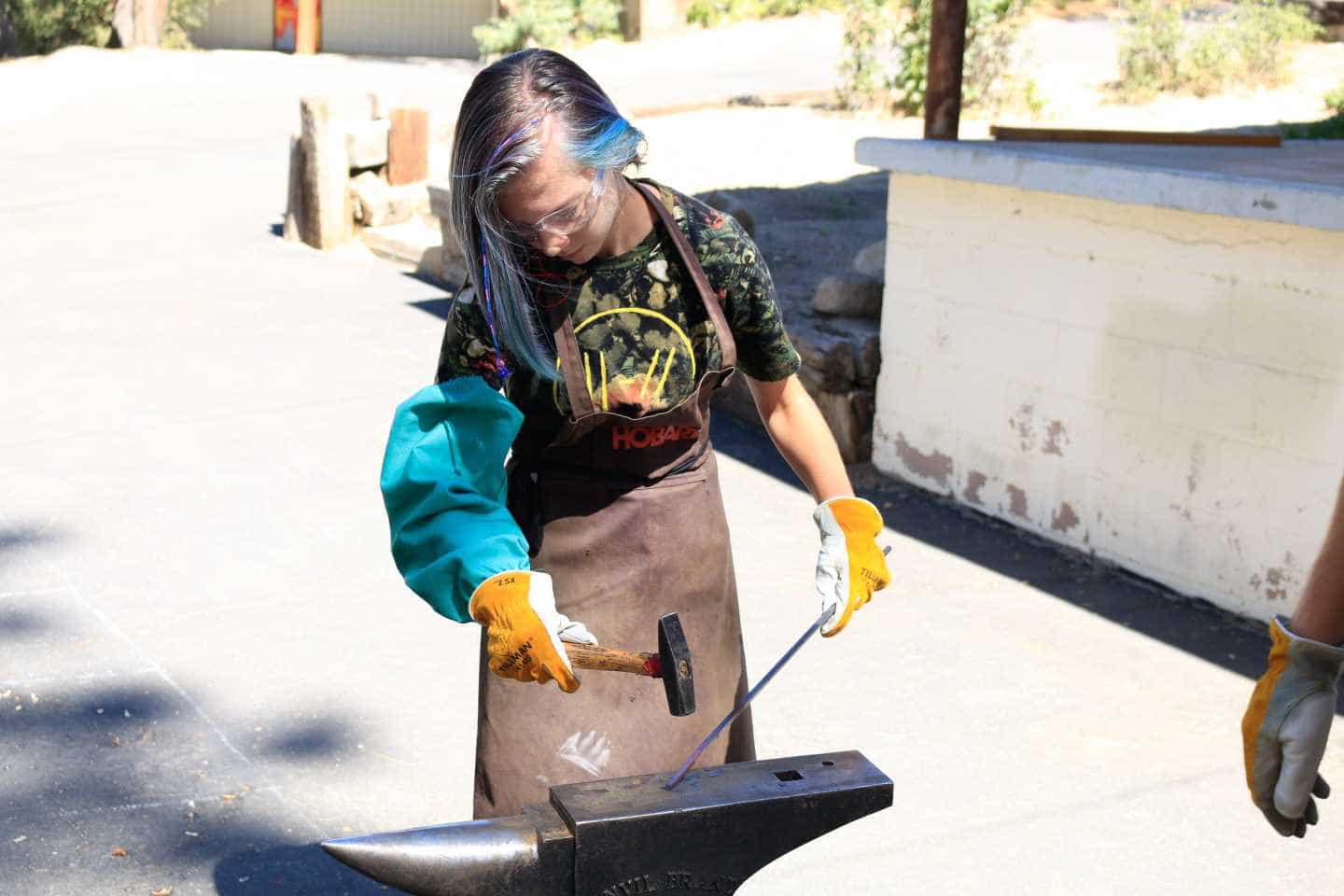 Girl metalsmithing.