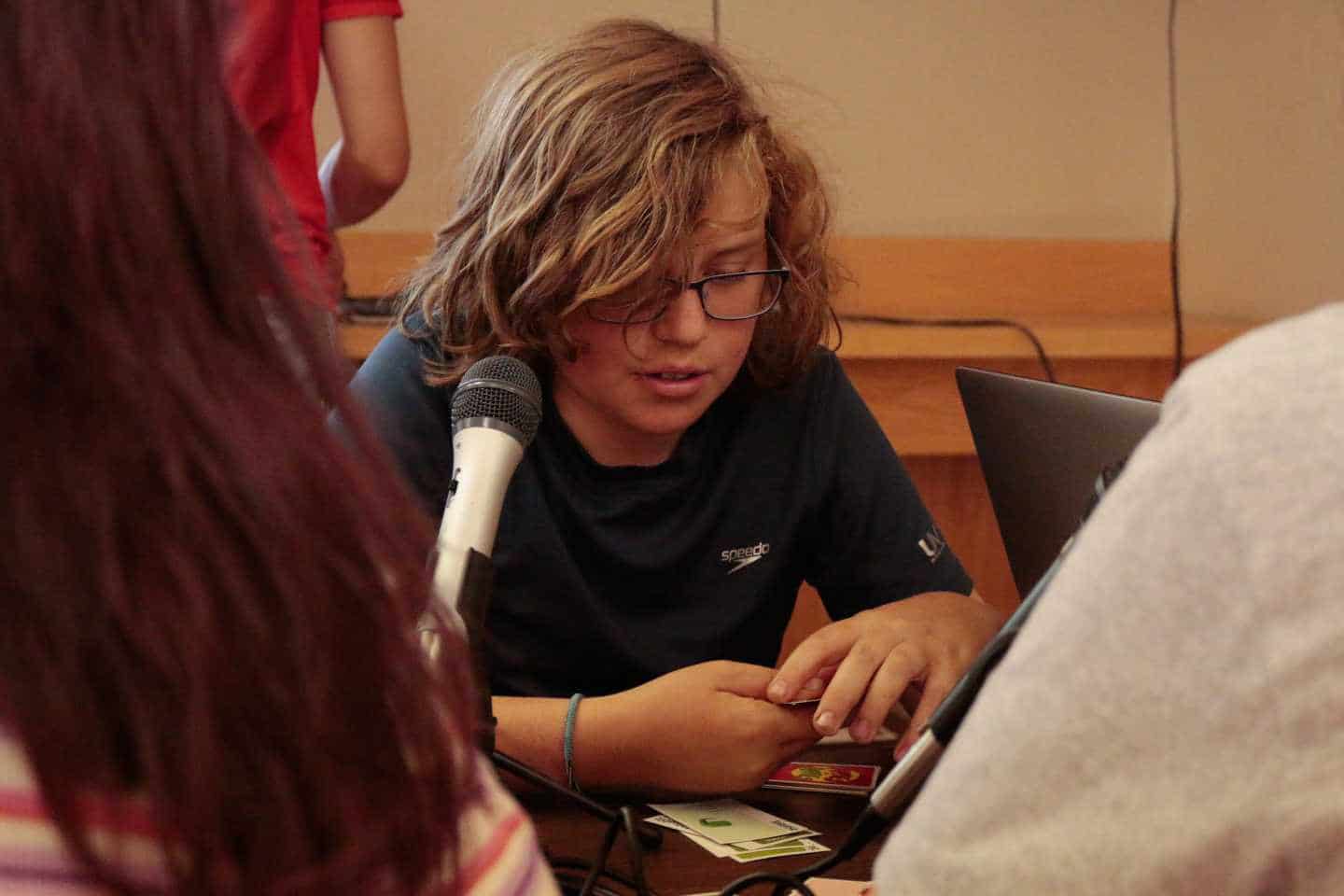 Boy in front of microphone.