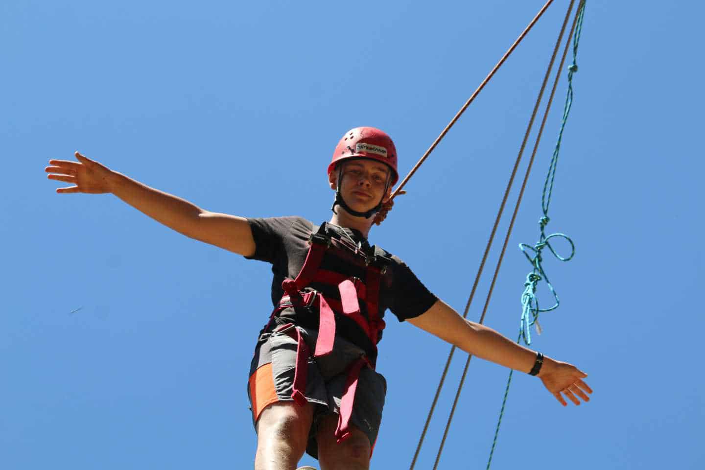 Boy on zipline looking at camera.